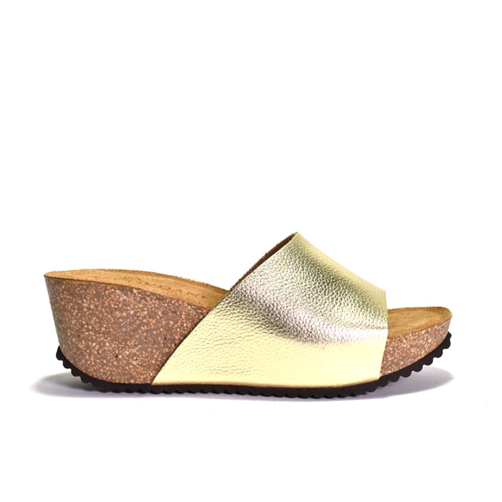 Gold wedge sandal with cork sole on a white background
