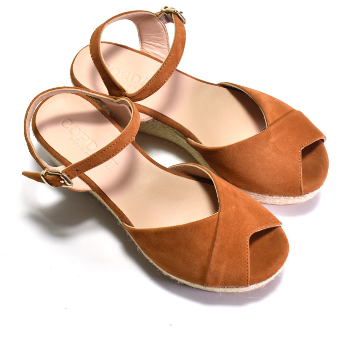 Pair of brown open-toe sandals on a white background