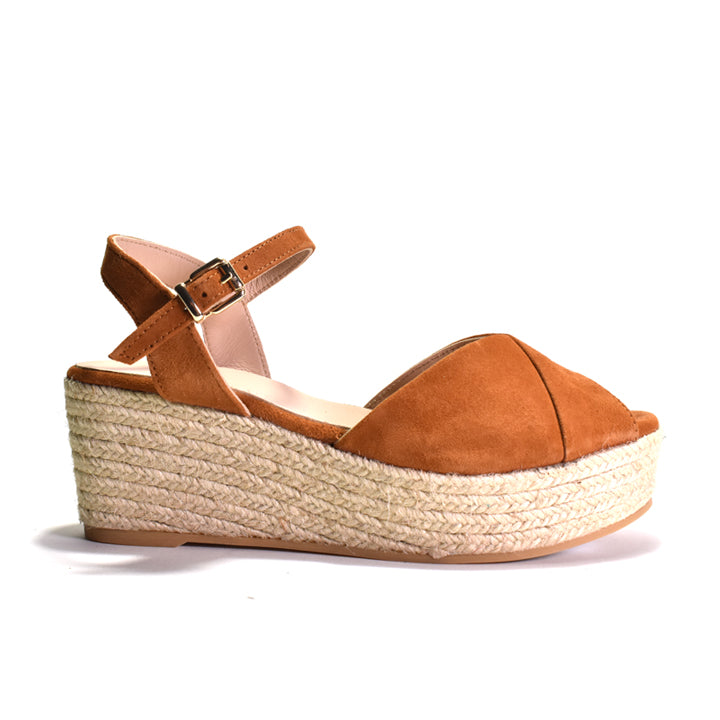Brown wedge sandal with espadrille sole on a white background