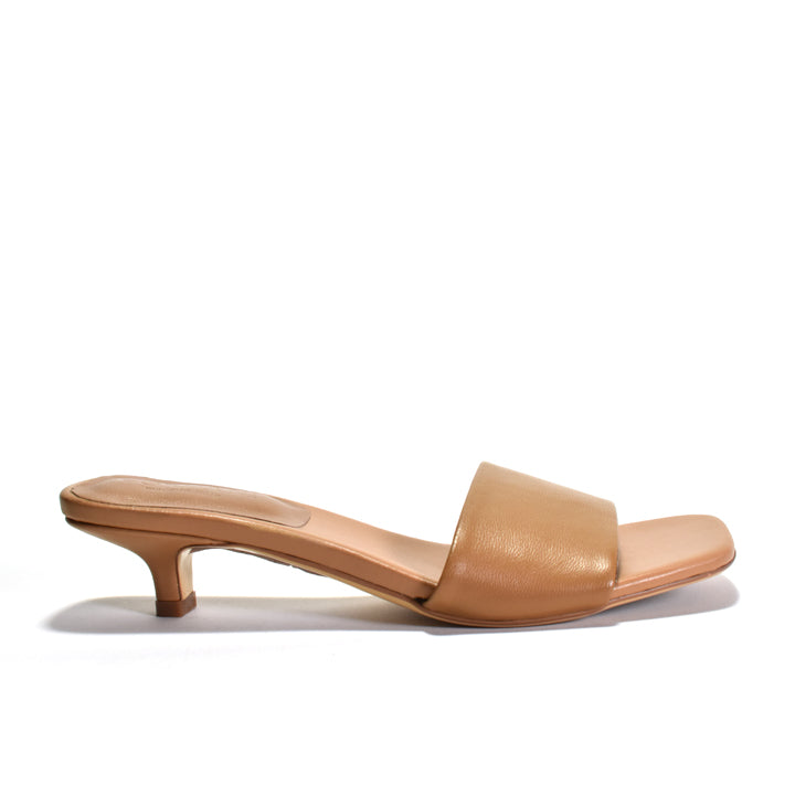 A single tan leather mule sandal with a low kitten heel and a wide front strap, shown in profile against a white background.