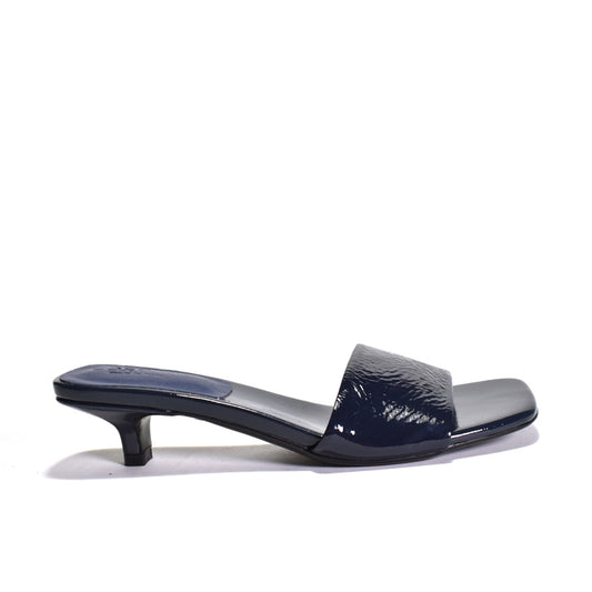 Navy blue high-heeled shoe on a white background