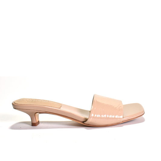 Nude-colored sandal with a low heel on a white background