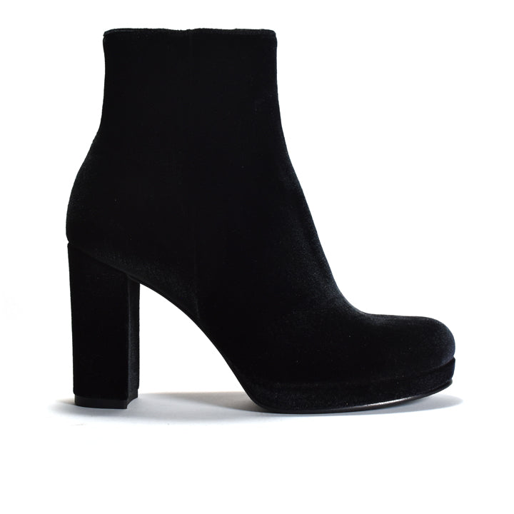 A single black velvet ankle boot with a chunky block heel and platform sole, shown in profile against a plain white background.