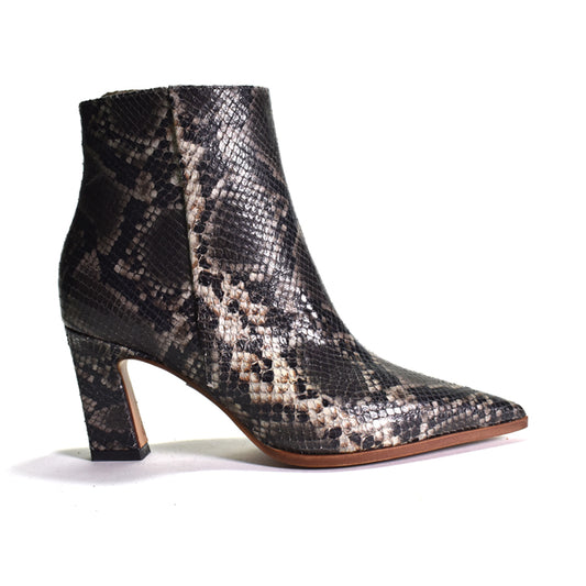 A single women's ankle boot with a pointed toe and block heel, featuring a black and beige snakeskin pattern on a white background.