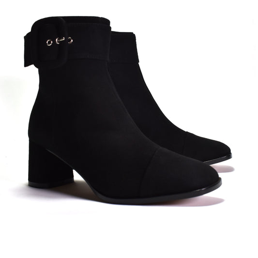 A pair of black ankle boots with a block heel, a side strap detail, and a wrapped buckle, shown on a white background.