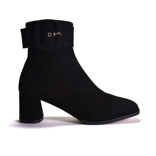 A black ankle boot with a block heel and a wide strap detail with buckle, shown against a plain white background.