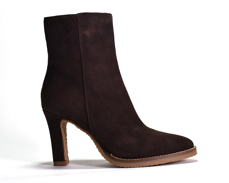 dark brown suede ankle boot with a wrapped tapered heel and outer sole stitch detail.