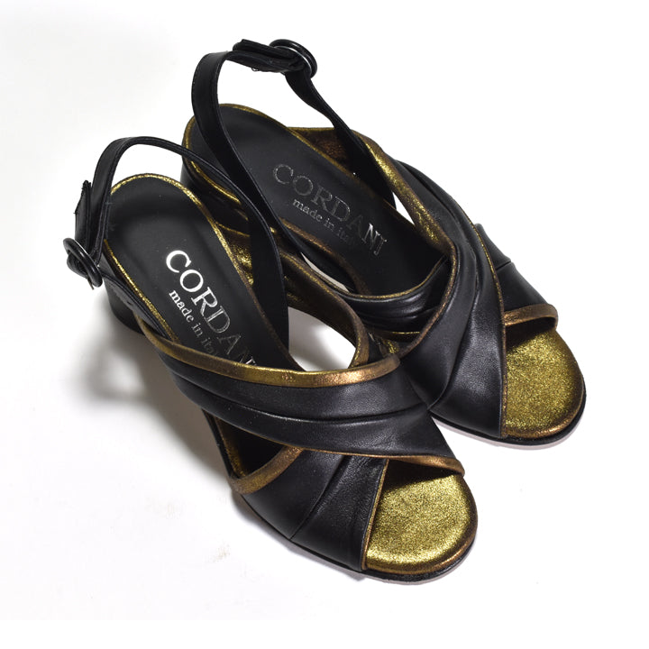 A pair of black leather slingback heeled sandals with metallic gold trim and gold insole branding, photographed on a white background.