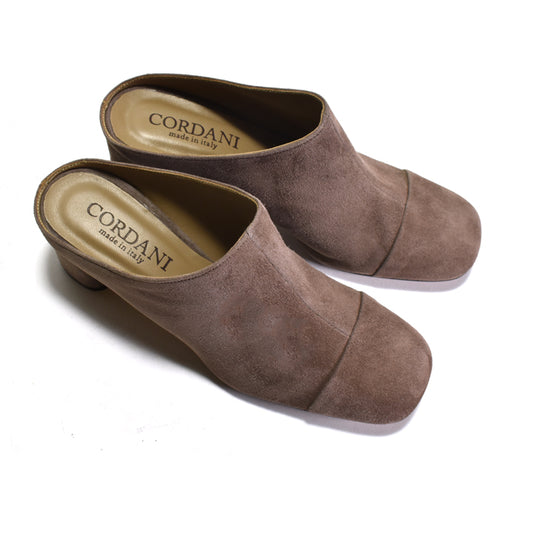Pair of brown suede clogs with 'Cordani' branding on a white background
