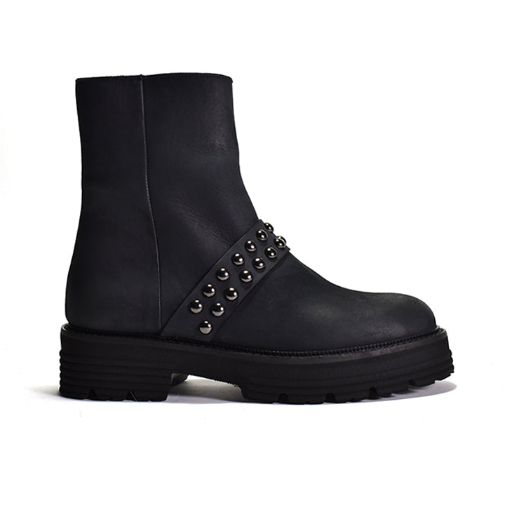 Black leather boot with studded details on a white background