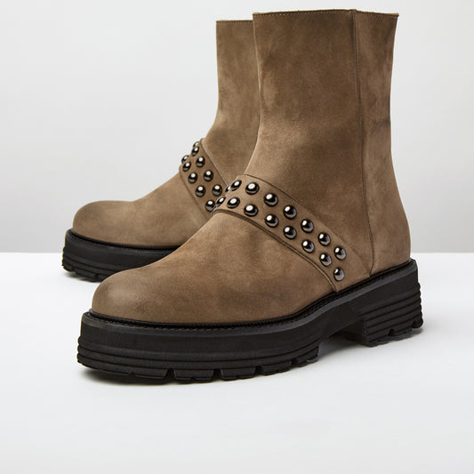 Brown suede boots with studded details on a white background