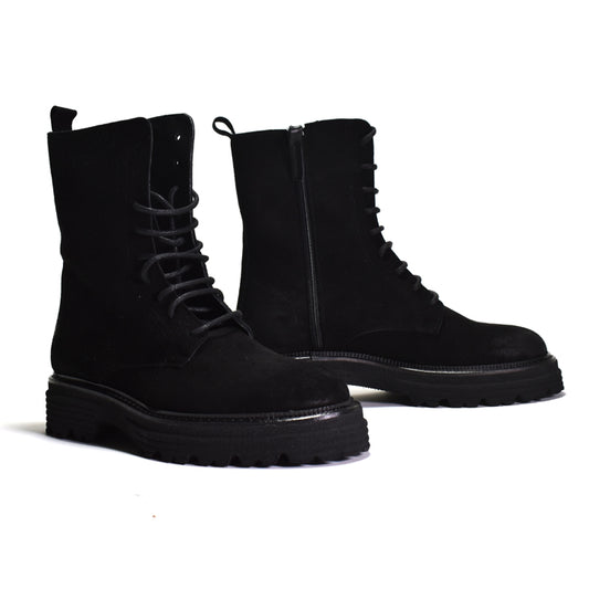 Pair of black suede lace up combat boot on a white background