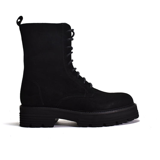 Black lace up combat boot on a white background