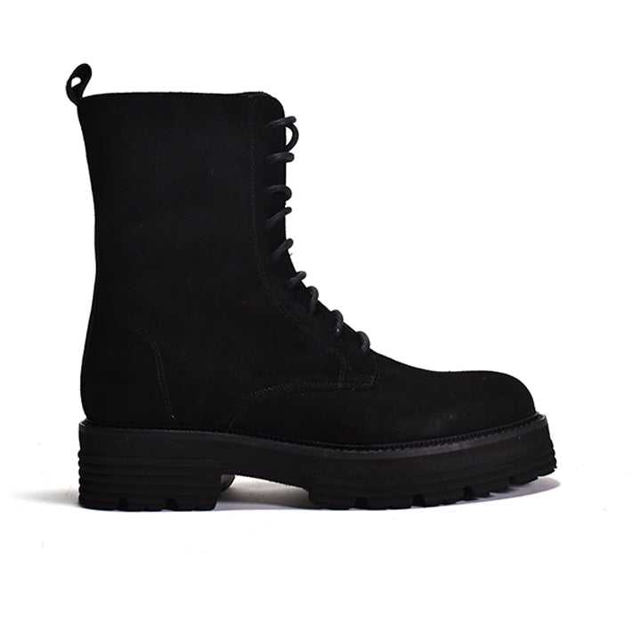 Black lace up combat boot on a white background