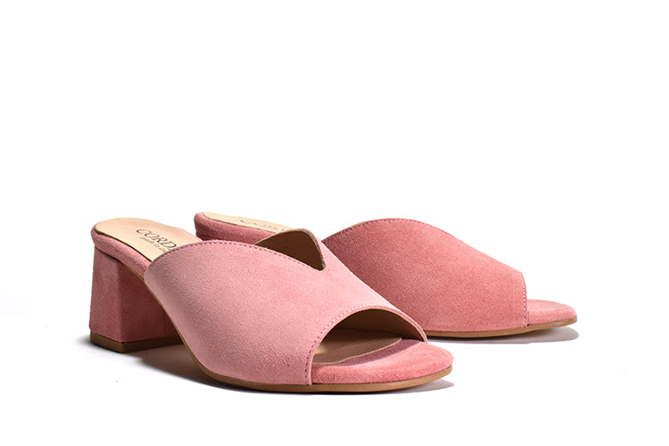 pair of pink suede mule sandal with a wrapped block heel and open toe