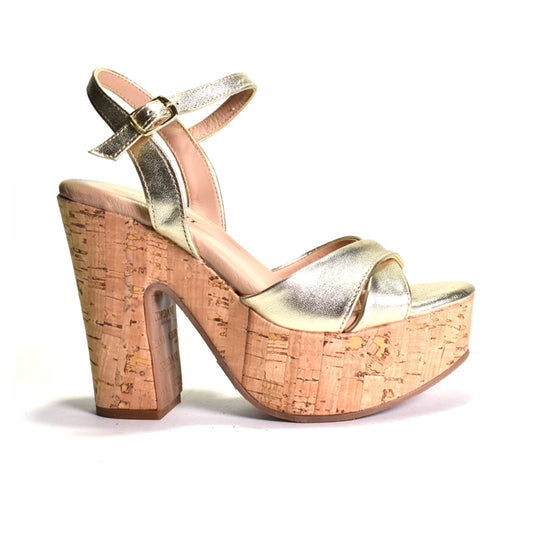 Gold high-heeled sandal with cork platform on a white background