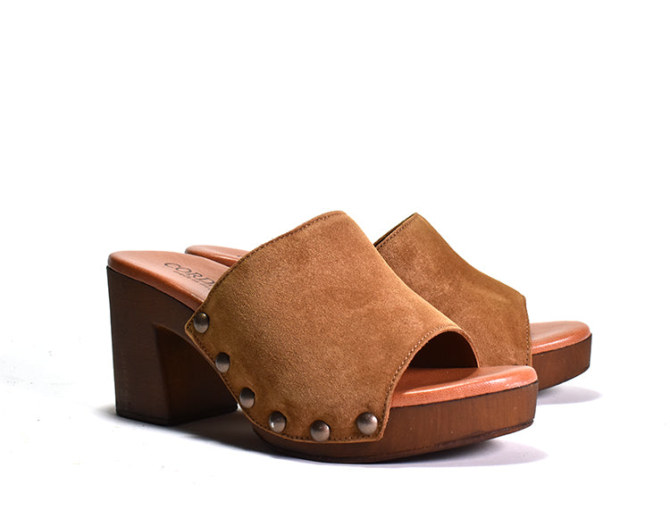 pair of brown suede Slip on sandal with stud detail on wood-like platform