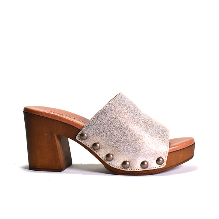 Wooden-heeled sandal with metallic strap and studs on a white background