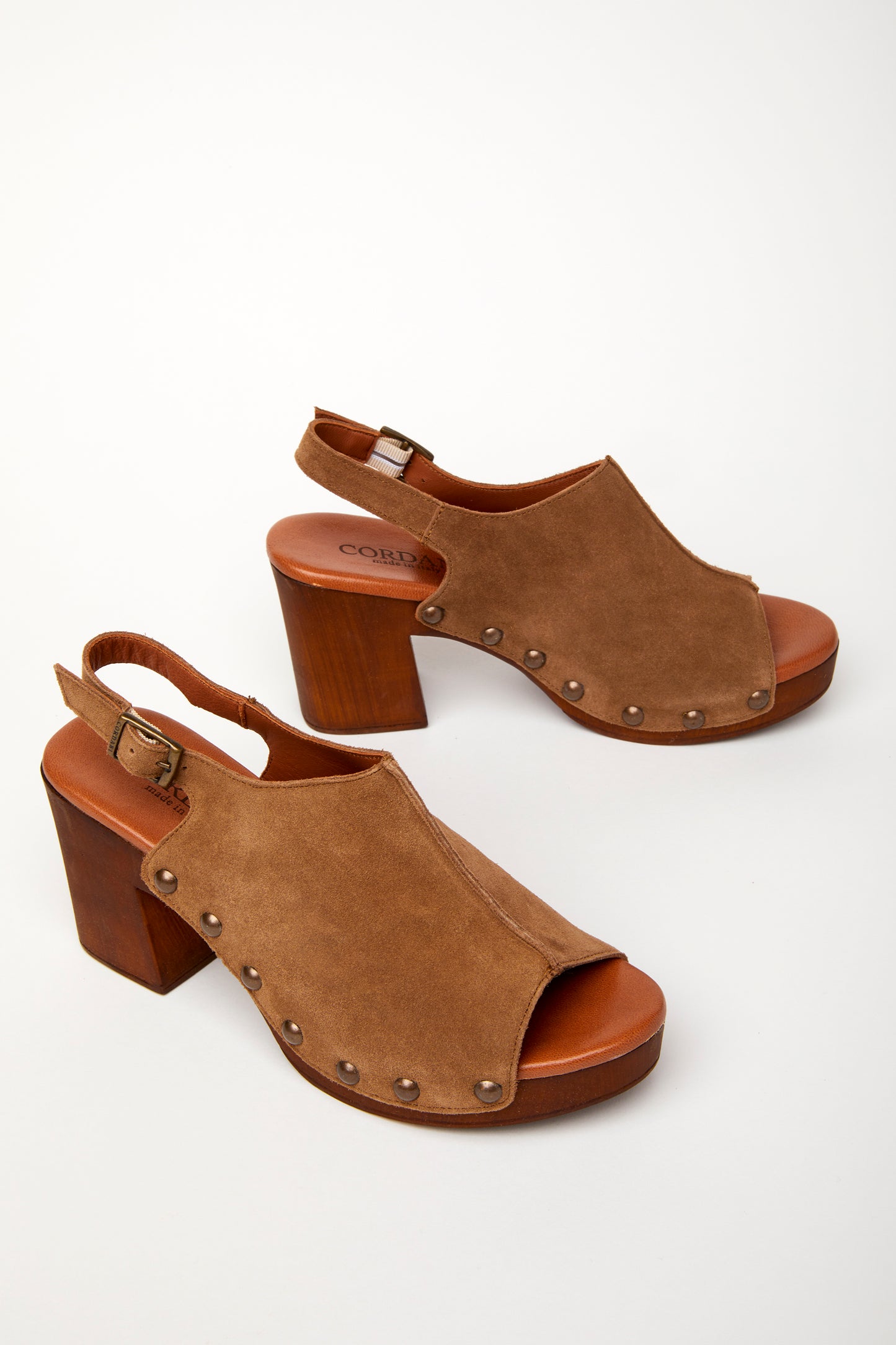 A brown peep-toe slingback heel with stud detail on a wood-like platform, with an adjustable buckle