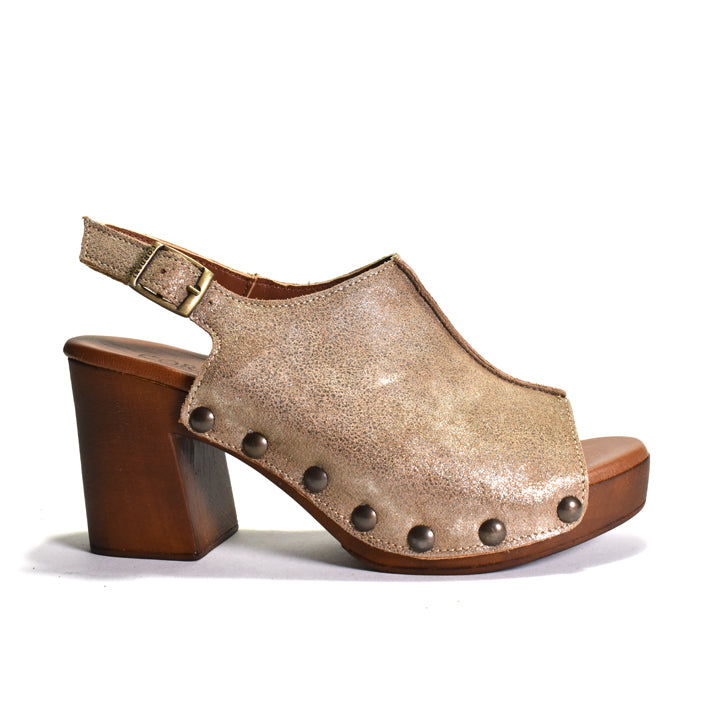 A single women's clog sandal in textured metallic gold-toned leather with a chunky brown wooden block heel and dark metal studs, shown from a side profile on a white background.