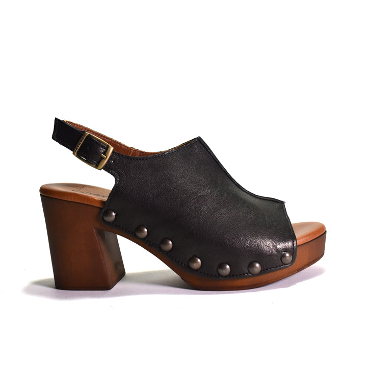 A black leather slingback sandal with a chunky brown wooden block heel, a platform sole, and decorative metal studs along the side, shown against a plain white background.