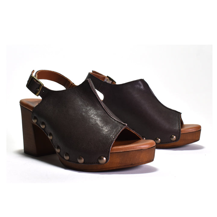 A pair of dark brown leather platform wedge sandals with block heels, studded details, and adjustable ankle straps, shown against a plain white background.