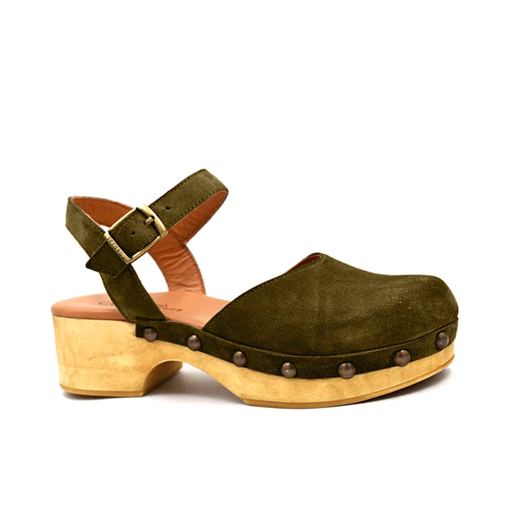 green suede clog with an adjustable ankle strap, buckle and stud detail on a wood-like platform