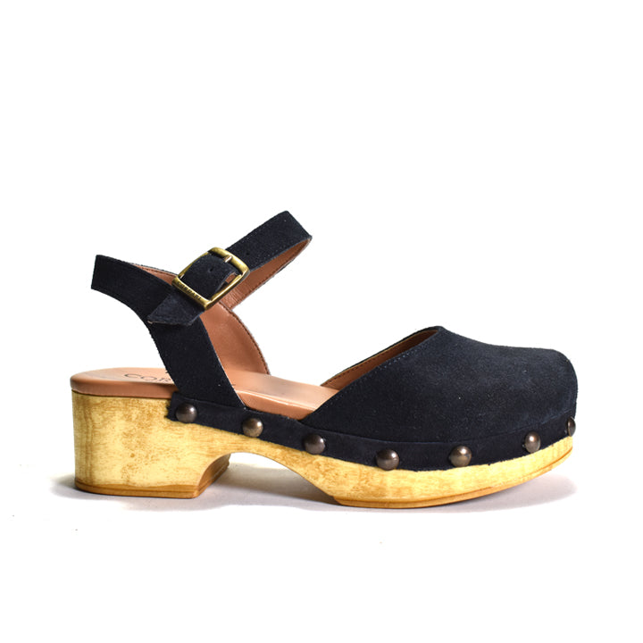 Navy clog sandal with gold sole on a white background