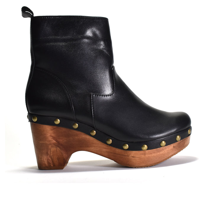 A black leather ankle boot with a chunky wooden block heel, a platform sole, and decorative gold-tone studs, shown from a side profile on a white background.