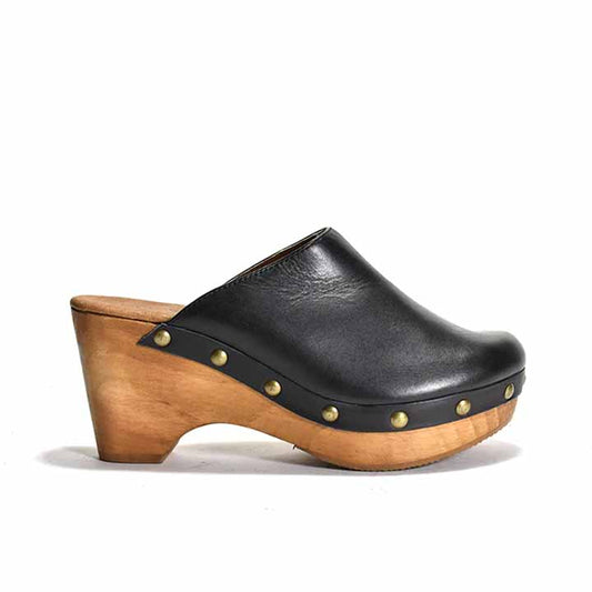 A black leather clog with a wooden heel and platform, featuring metal eyelets 