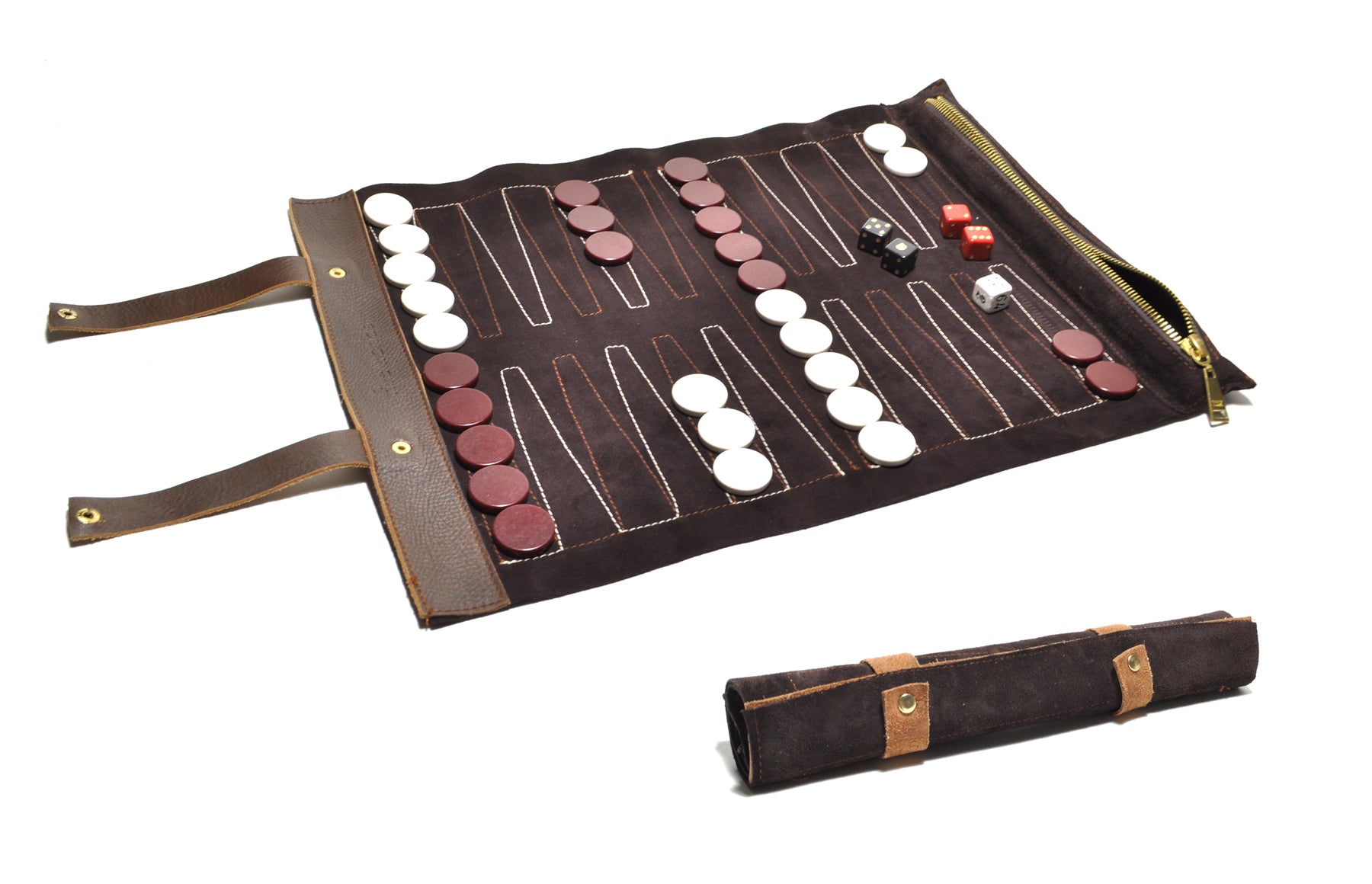 A travel backgammon set rolled out, with game pieces and leather trim visible.
