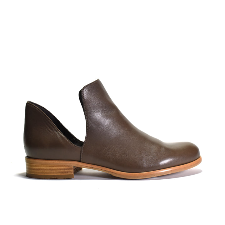 A single dark brown leather ankle boot with a low stacked wood-look heel, shown in a side profile on a white background.