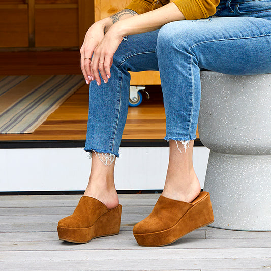 Brown suede clog on a wrapped wedge heel, with a leather lining.