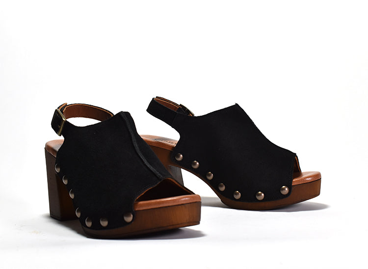 A black peep-toe slingback heel with stud detail on a wood-like platform, with an adjustable buckle