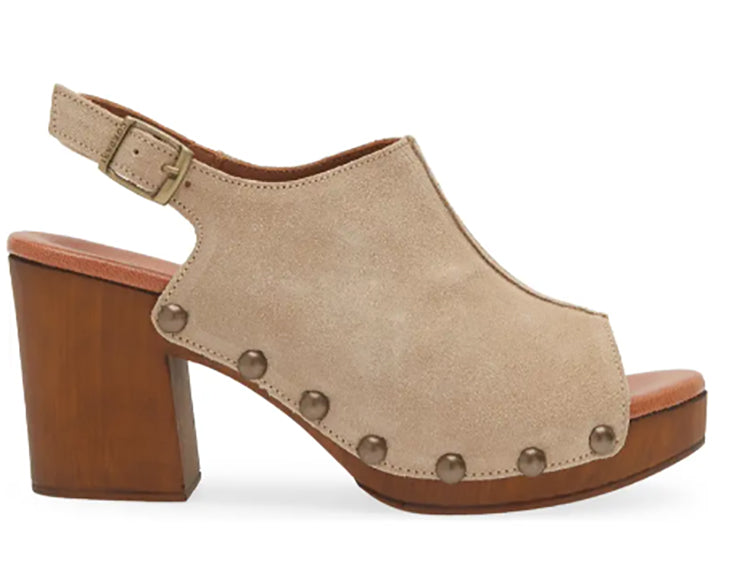 A white peep-toe slingback heel with stud detail on a wood-like platform, with an adjustable buckle