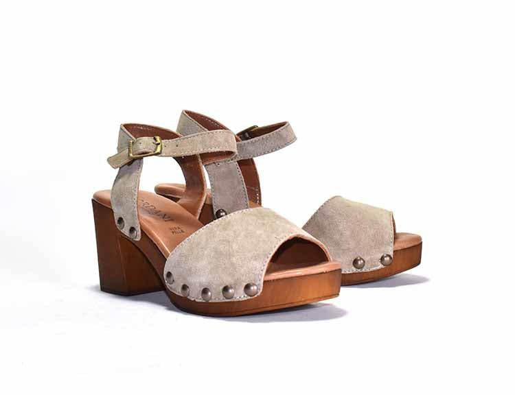 white sandal with ankle strap and stud detail, on a wood-like platform heel.