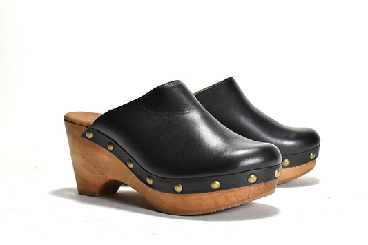 pair of black leather clog with a wooden heel and platform, featuring metal eyelets 