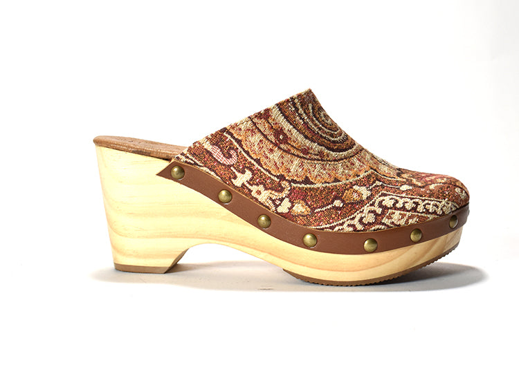 A brown and beige patterned clog with a wooden heel and a rubber outsole.