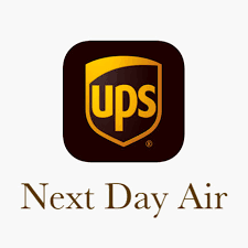 The image shows the UPS logo, which is a shield with the letters 'UPS' in a yellow circle on the left side, and the text 'Next Day Air' below it.