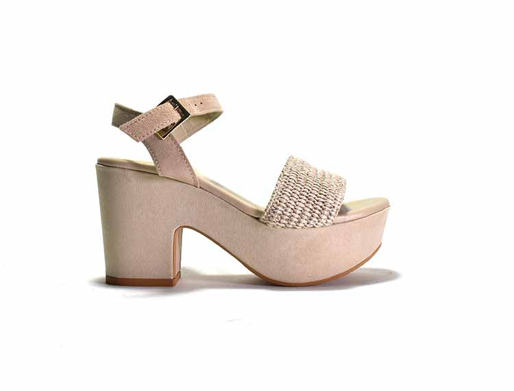 A white platform sandal with a woven fabric and suede upper, featuring a suede wrapped heel and an adjustable metal buckle.