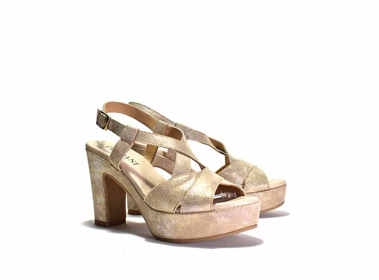 metallic platform sandals with criss-crossing straps, an adjustable metal buckle, and a chunky heel.